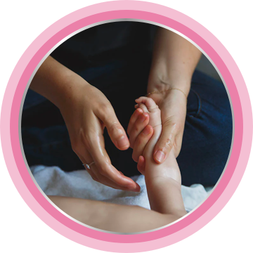 Parent applying barrier cream to baby's arms and hands.